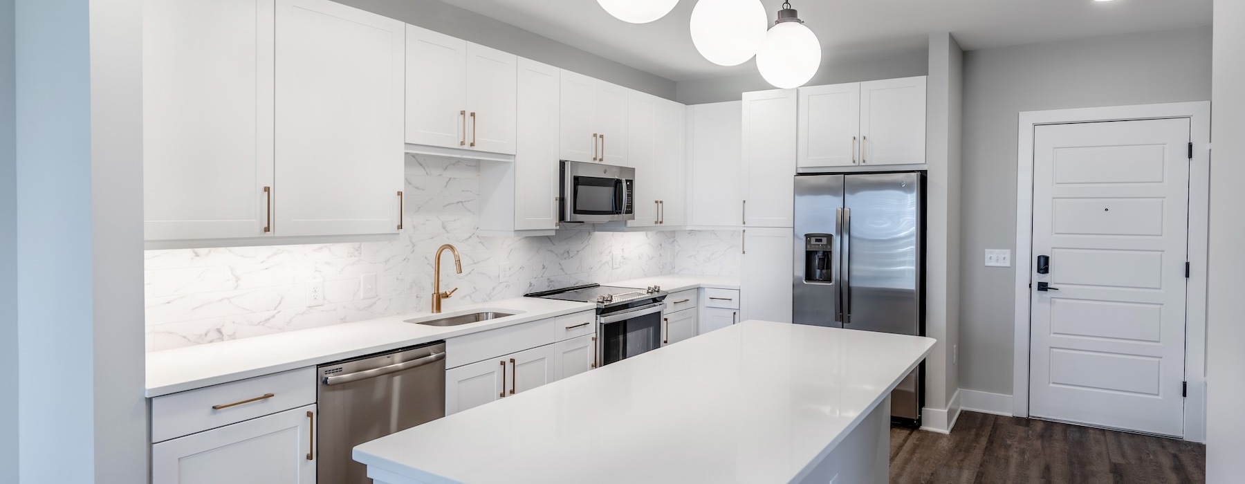 a kitchen with white cabinets