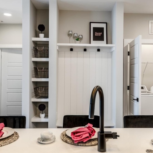 a kitchen sink with a washer and dryer in a closet