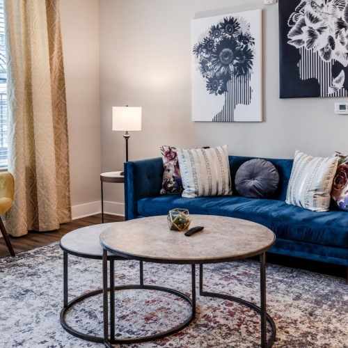 a living room with a blue couch and a coffee table