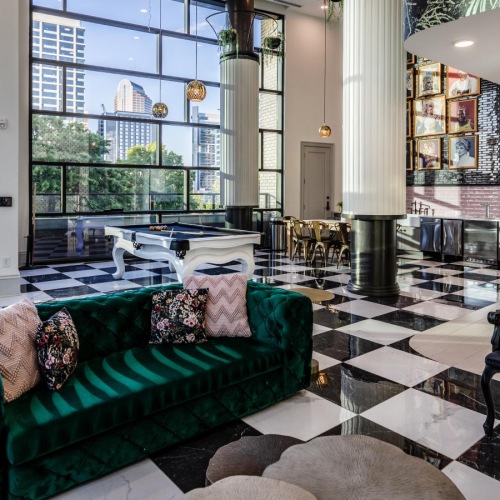 a room with a couch and chairs