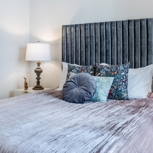 a bed with blue and white pillows